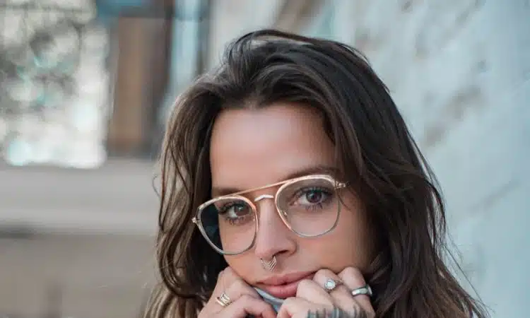 woman in blue sweater wearing eyeglasses