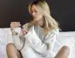 woman in white knit sweater sitting on white sofa