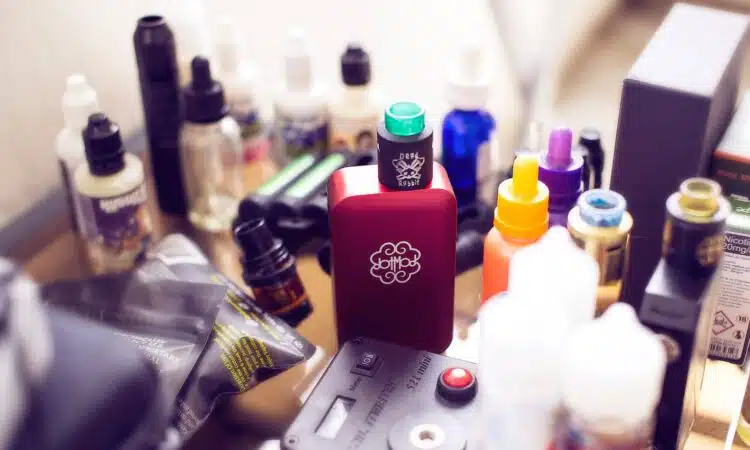 red box mod vape beside e-juice bottles